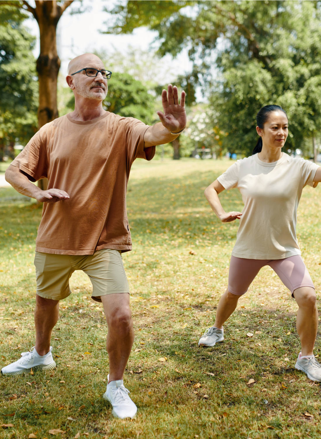 stock photo mature couple enjoying practicing tai chi outdoors